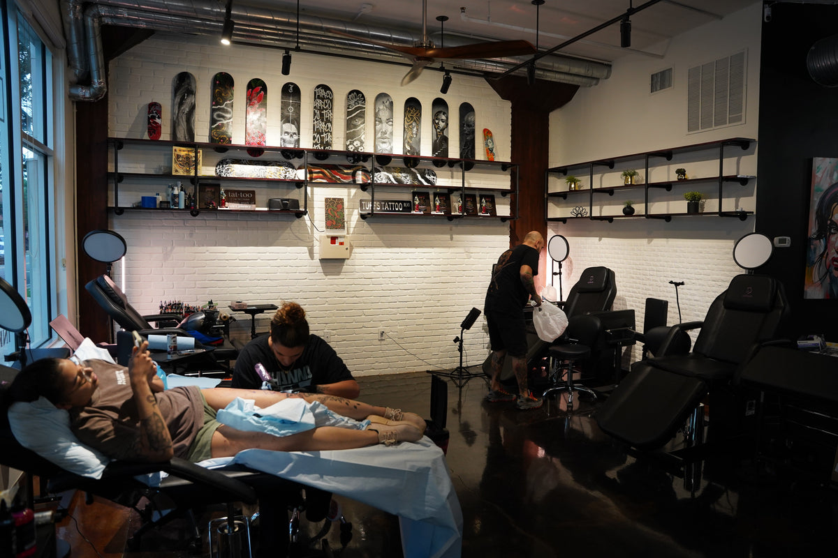 Tattoo artist working on a client inside the Tuff Tattoos studio in Tampa