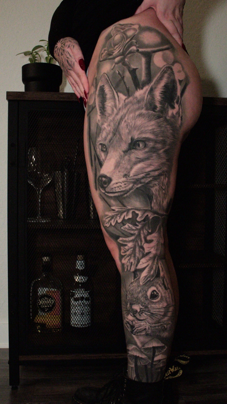 Black and grey fox and botanical leg tattoo by Carlos