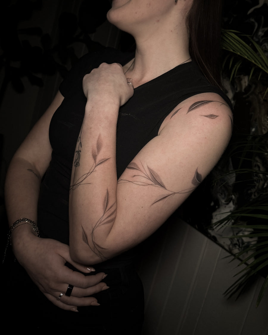 Fine line botanical tattoo by Carlos