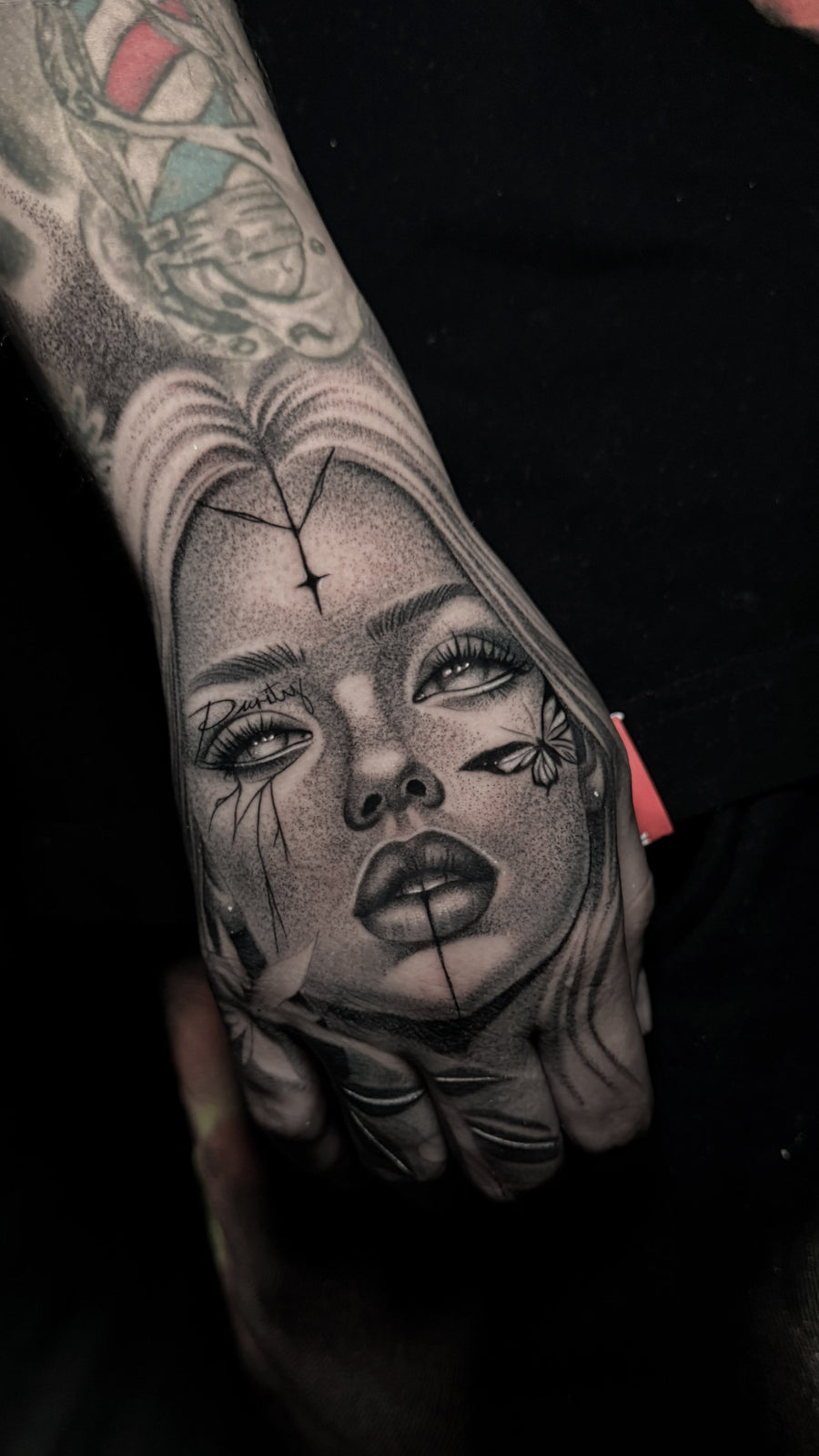 Black and grey portrait tattoo of a woman by Carlos